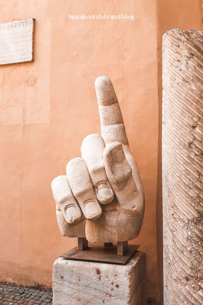 Statue of an enormous hand pointing at the sky