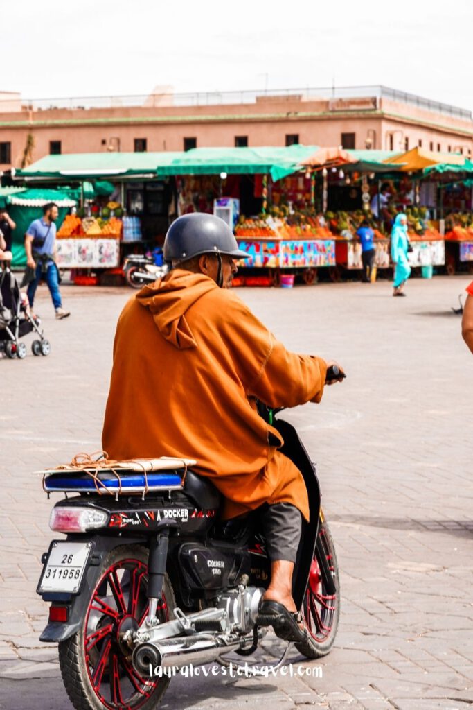 Man on a motor scooter at the Jemaa El-Fna square in Marrakesh