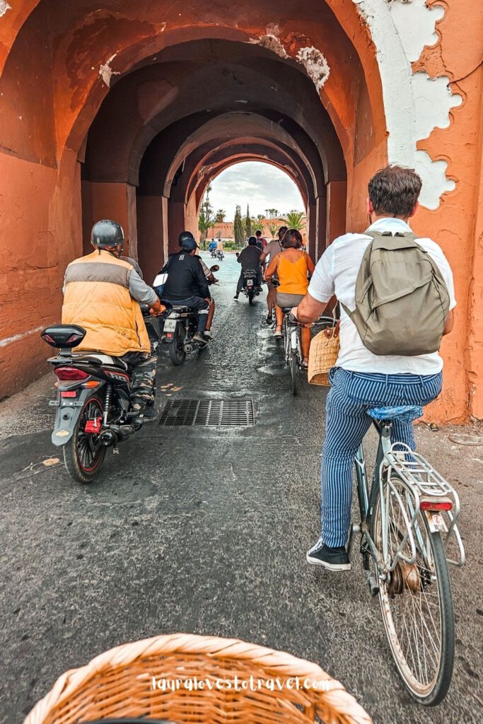 Cycling through the city gate of Marrakesh Morocco