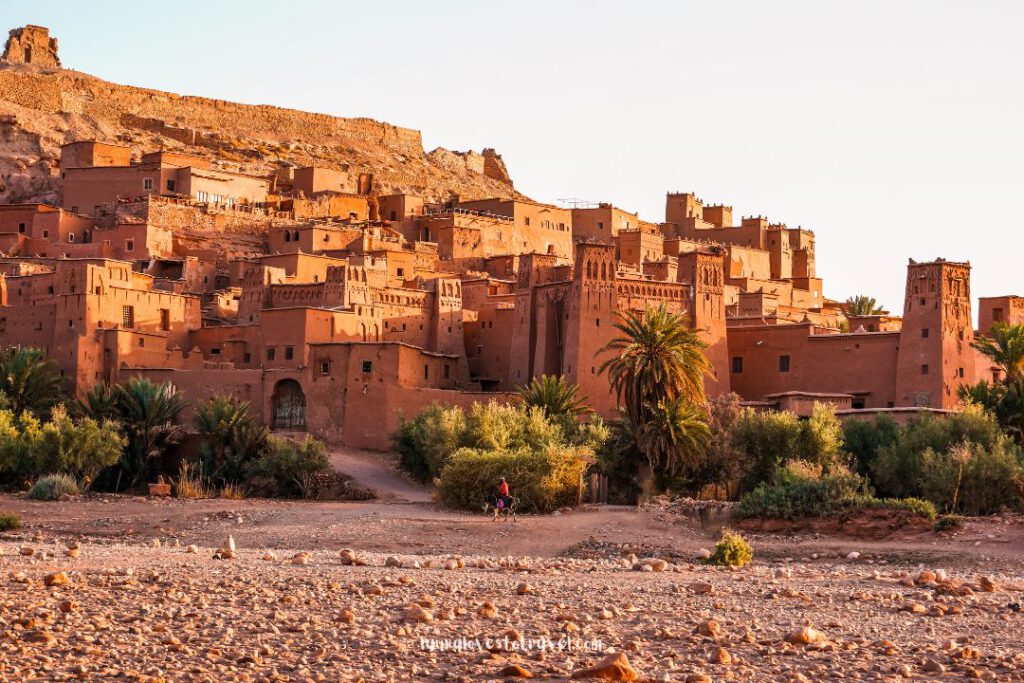 A man on a donkey in front of Aït Ben Haddou